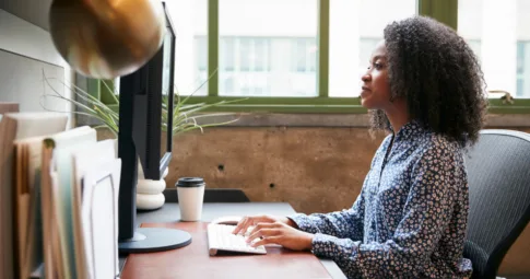 A business woman working at a computer