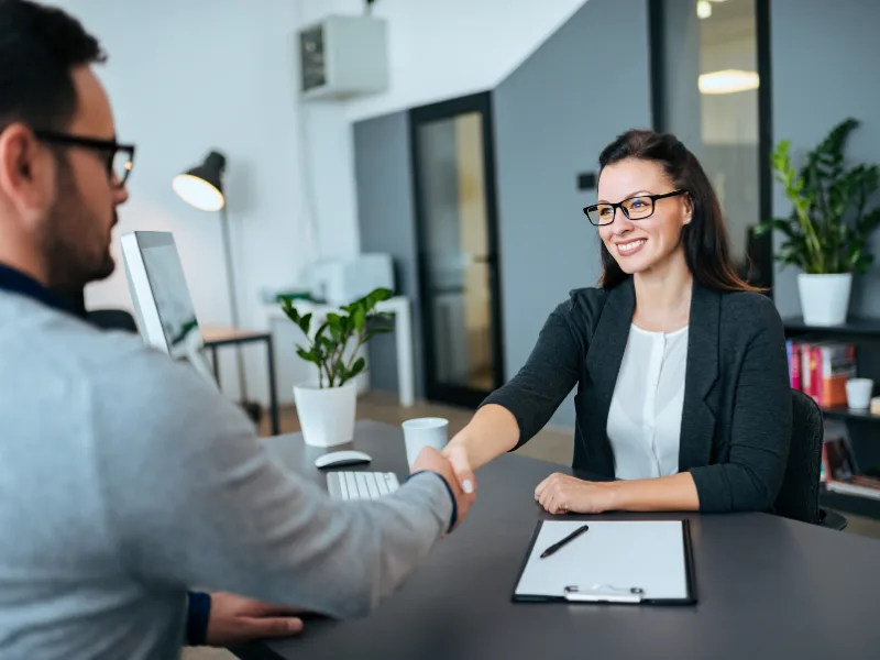 A professional woman interviewing a content writer.