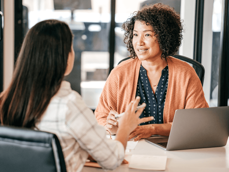 An HR professional talking to an employee.