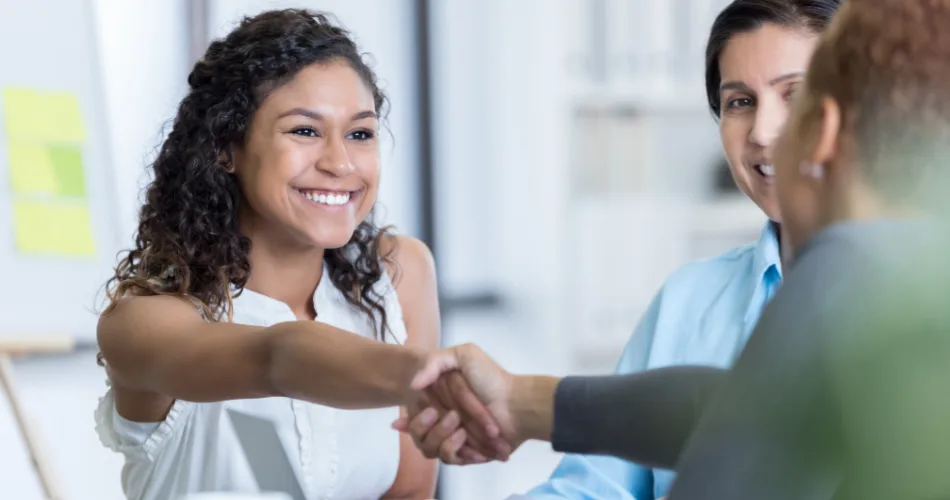 A content marketing intern shaking hands with her team