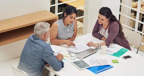 Three people working together in an office