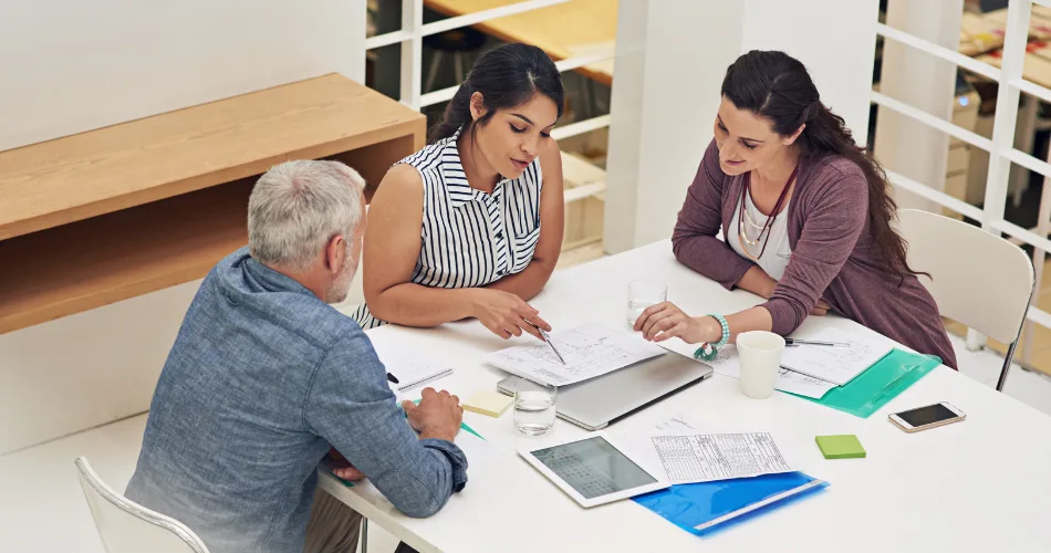 Three people working together in an office