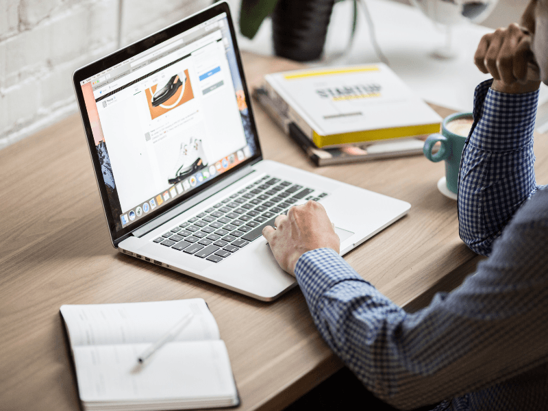 A man writing a blog on a laptop.