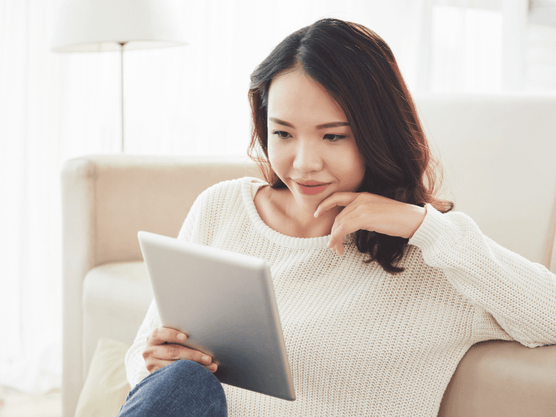 A woman reading a blog on a tablet.